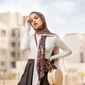 woman wearing white long-sleeved top and black pleated skirt