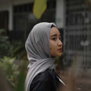 woman in white hijab and black jacket